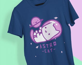 May include: A navy blue t-shirt with a purple graphic of a cat in a spacesuit holding a planet. The text "ASTRO -CAT- " is below the graphic.