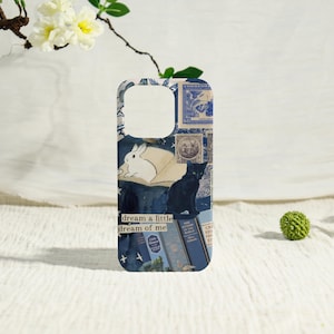 May include: A phone case featuring a collage design with a white rabbit, a black cat, and vintage postage stamps in shades of blue. The case also includes the text "dream a little dream of me."