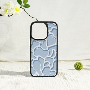 May include: A black phone case with a light blue water-like pattern. The case has a black border and a cutout for the camera. The design features abstract shapes in shades of blue and white.