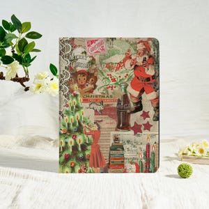 May include: A rectangular Christmas-themed notebook with a collage design. The collage features Santa Claus, a Christmas tree, and vintage-style illustrations. The notebook has a black border and is decorated with text that reads "Merry Christmas".