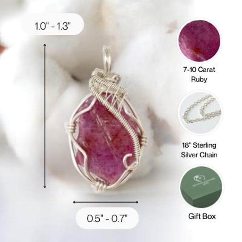 May include: A wire-wrapped pendant featuring a raw, deep pink ruby gemstone. The pendant measures 1.0 to 1.3 inches in height and 0.5 to 0.7 inches in width. It includes a 7-10 carat ruby, an 18-inch sterling silver chain, and a green gift box.
