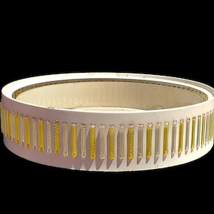 May include: A circular white ceiling light fixture featuring a perforated inner mesh screen and a decorative outer ring composed of alternating vertical clear and yellow translucent glass rods arranged in a repeating pattern around the perimeter.