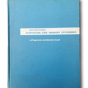 May include: A vintage book titled "FURNITURE FOR MODERN INTERIORS" by Mario Dal Fabbro. The book has a light blue cover with white text and a white band. The book is a "Progressive Architecture book".