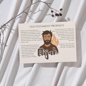 May include: A beige card with the text "OLD TESTAMENT PROPHETS" and information about Elijah. The card features an illustration of Elijah with a beard and a flame. The text includes a Bible verse.