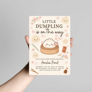 May include: A baby shower invitation with a dumpling theme. The card features the text "Little Dumpling is on the way" with illustrations of dumplings, flowers, and chopsticks. The invitation is for Amelia Pond's baby shower.