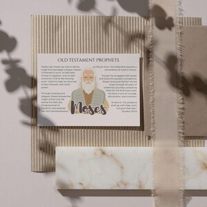 May include: A printed card with the title "OLD TESTAMENT PROPHETS" and an illustration of Moses. The card includes text describing Moses' life and role in the Old Testament. The background features neutral tones and textures.