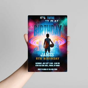 May include: A birthday party invitation with a basketball theme. The invitation features the text "IT'S TIME TO PLAY BIRTHDAY JAM" with the name "JAMES" and "6TH BIRTHDAY". A young person in a basketball uniform is holding a basketball. The background is a colorful galaxy.