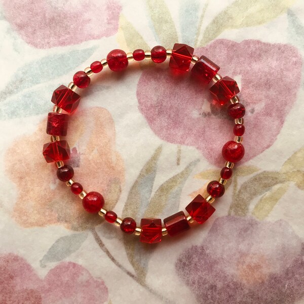 Pte-109 Bracelet ruby red light gold stretch 8 inches. Free Shipping.