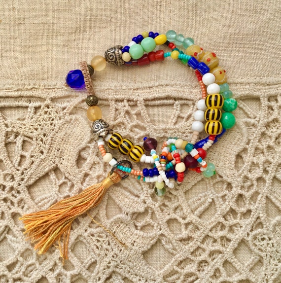 METAL BEAD BRACELET W/TASSEL YELLOW METAL BEAD BRACELET W/TASSEL YELLOW