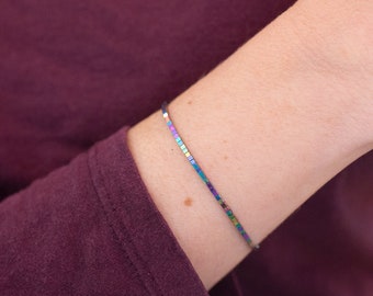 Thin and fluid rainbow bracelet, made of surgical steel chain and tiny colored cubic hematite beads