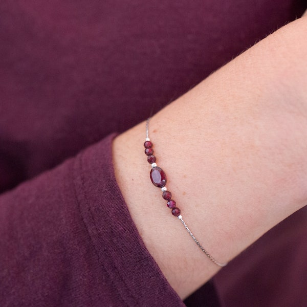 Bracelet with thin and fluid steel chain and small faceted garnet beads