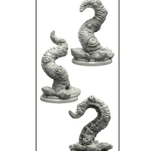 Puede incluir: Tres esculturas grises con forma de tentáculo con múltiples detalles de ojos. Cada tentáculo descansa sobre una base rocosa. La palabra "TENTACLES" está impresa en la parte superior de la imagen.