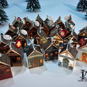 May include: A collection of miniature house-shaped advent calendars. Each house features a different shop name, such as "Toy Shop" and "Christmas Shop", and a numbered tag. The houses are brown, green, and red with a snowy background.