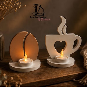 Könnte beinhalten: Zwei hölzerne Kerzenhalter mit LED-Teelichtern. Ein Halter ist wie eine Kaffeebohne in hellem Beige geformt, der andere ist eine weiße Kaffeetasse mit herzförmigem Ausschnitt und Dampf-Detail. Beide stehen auf runden Holzsockeln.