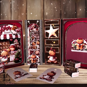 May include: A festive display featuring gingerbread-themed decorations. The scene includes decorative boxes, tags, and miniature books, all adorned with gingerbread people and holiday motifs. The color palette is dominated by warm reds, browns, and whites, creating a cozy, seasonal atmosphere.