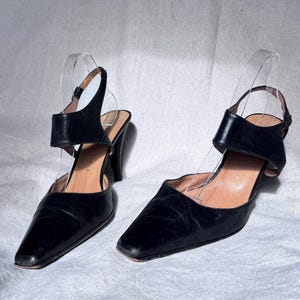y2k black leather stiletto heels / Martinez Valero sculptural vamp pumps