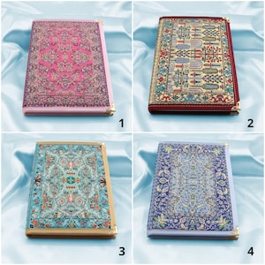 May include: Four different patterned notebooks with gold trim. The notebooks have a pink, red, blue, and purple background. Each notebook has a different pattern of flowers and geometric shapes.