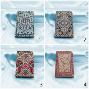 May include: Four small, rectangular cases with decorative, patterned covers. The cases have gold-coloured metal edges. The patterns include a tree design, a geometric design, and floral designs in various colours, including blue, red, and cream.