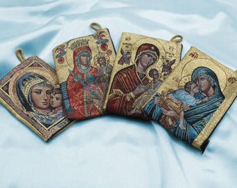 May include: Four small, rectangular, fabric pouches with embroidered images of religious figures. Each pouch has a gold trim and a loop for hanging. The images are of Mary and Jesus, with the text "MP OY" on one pouch.