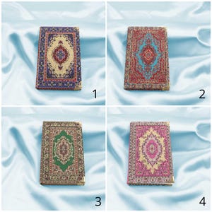May include: Four small notebooks with different patterned covers. Each cover features a colorful design inspired by traditional Turkish rugs. The notebooks are arranged in a grid pattern.