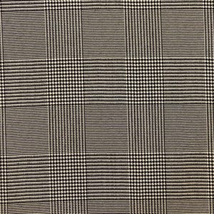 Pu&ograve; includere: Primo piano di un tessuto bianco e nero con motivo a pied-de-poule e righe. Il design presenta una disposizione a griglia di quadrati alternati a pied-de-poule e righe, creando un effetto visivo strutturato. Adatto per abbigliamento o arredamento.