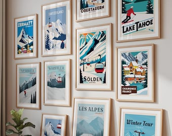 May include: A display of framed travel posters showcasing ski resorts and mountain scenes. Destinations include Zermatt, Switzerland, Lake Tahoe, and Les Alpes. The posters, in wooden frames, are arranged on a wall and floor, creating a gallery effect.