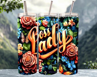 May include: Three cylindrical tumblers with metal straws, featuring a vibrant floral pattern of red roses, blue flowers, and orange butterflies on a dark background. The text "Boss Lady" is written in large, stylized orange script across the tumblers.