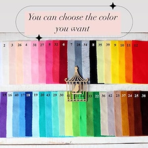May include: A colour chart with 44 fabric swatches, numbered 1 through 44. The swatches are arranged in two rows. The top row has 12 swatches, and the bottom row has 32 swatches. The swatches are a variety of colours, including white, pink, red, grey, black, yellow, orange, green, blue, and brown.