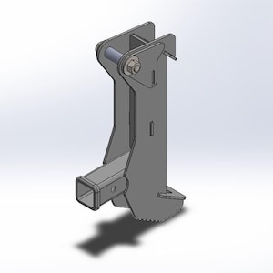 May include: A grey metal trailer hitch receiver with a square opening and a bolted joint. The design includes a vertical support structure and a lower angled section.
