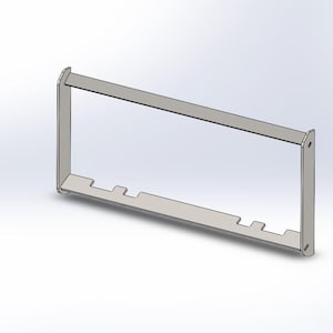 May include: A metal frame with a rectangular opening and several cutouts along the bottom edge.
