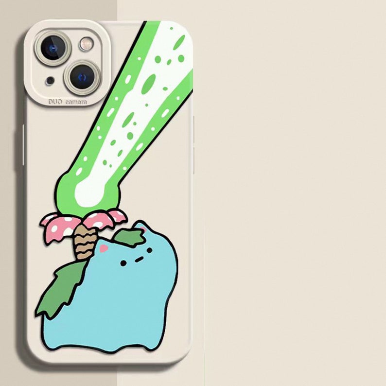 May include: A phone case featuring a cartoon illustration of a blue creature with green leaves and a green and white design. The case has a white border and a camera cutout.