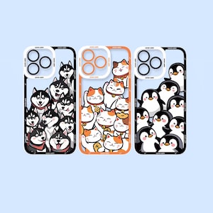 以下が含まれることがあります： 動物のデザインが異なる3つの携帯電話ケース。最初のケースは、黒と白のハスキー犬のグループが特徴です。2番目のケースは、オレンジと白の猫のグループが特徴です。3番目のケースは、黒と白のペンギンのグループが特徴です。