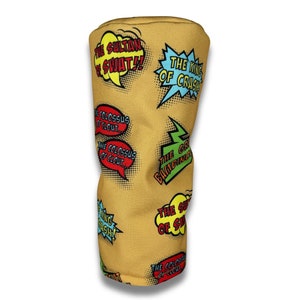 May include: Mustard-colored golf club head cover with comic book style speech bubbles. Text includes "THE SULTAN OF SWAT!!", "THE KING OF CRASH", and "THE COLOSSUS OF CLOUT".