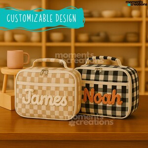 May include: Two personalized lunch bags. One is tan and cream checkered with the name "James" in cream letters. The other is black and white checkered with the name "Noah" in orange letters. Both have handles and zippers. Text above reads "CUSTOMIZABLE DESIGN".