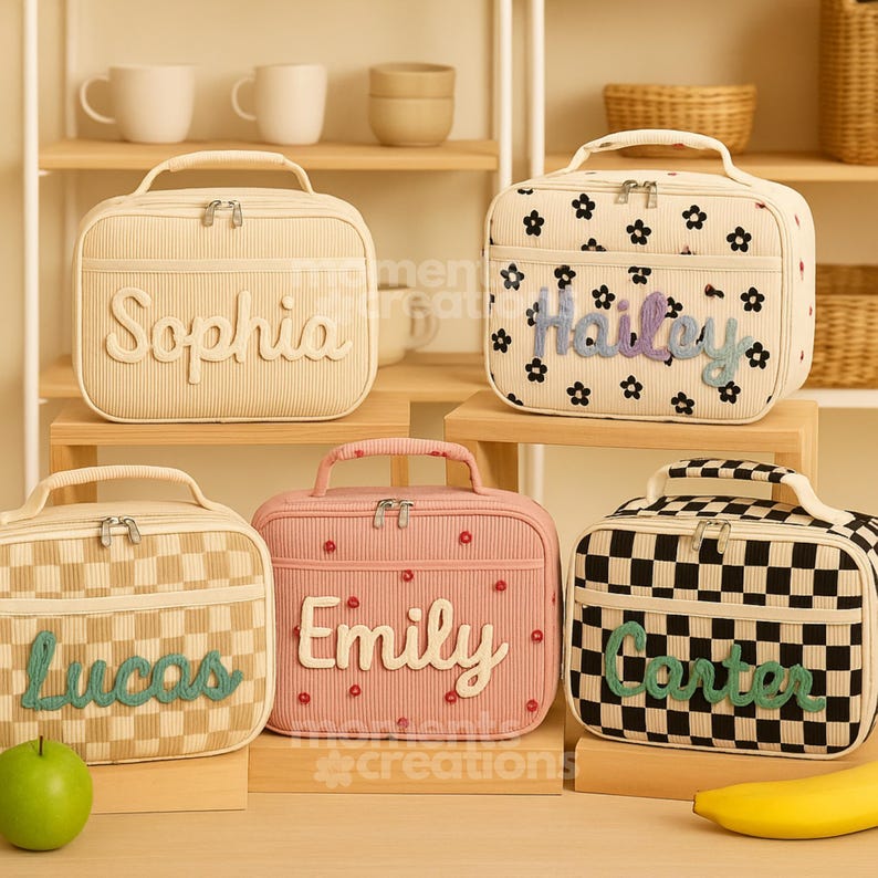 May include: Five personalized lunch bags in various colors and patterns. The bags feature names like "Sophia," "Hailey," "Lucas," "Emily," and "Carter." Designs include floral, checkered, and striped patterns, with matching handles and zippers.
