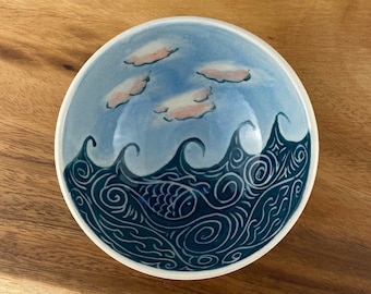 Small pottery bowl with wave and cloud pattern.