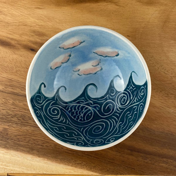 Small pottery bowl with wave and cloud pattern.