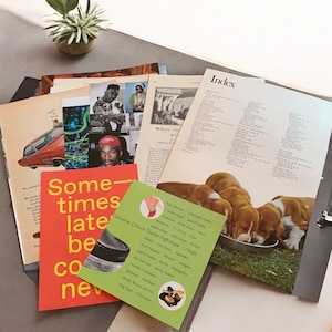 May include: A collection of vintage magazines and printed materials, including a red book with the text "Sometimes late be come new." A green card lists Converse Chuck Taylor high-tops and clogs. The image includes a photo of puppies.