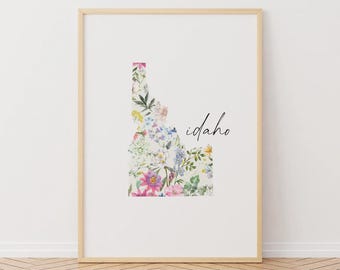 May include: A floral print of the state of Idaho with the word "Idaho" in black script.