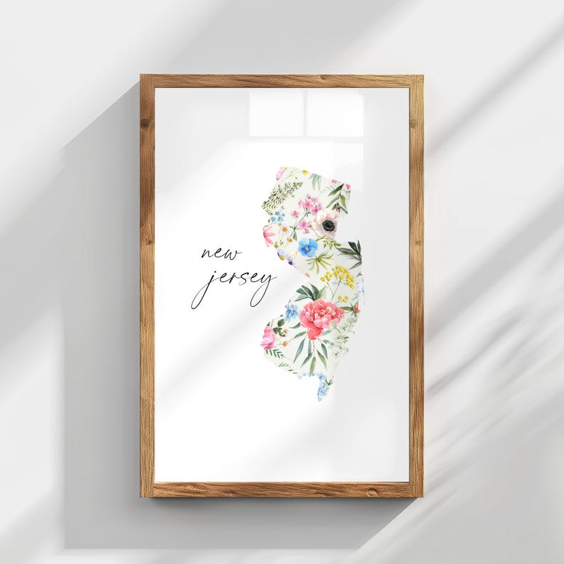 May include: A framed print of the state of New Jersey, outlined in floral designs. The print is on white paper with the words "new jersey" written in black cursive script.
