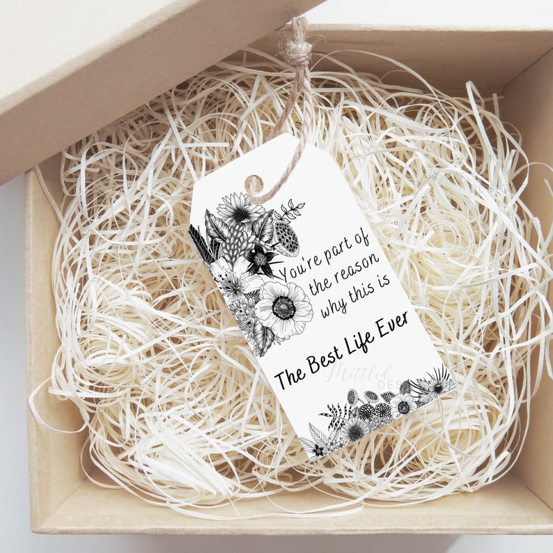 May include: A white gift tag with black floral illustrations and the text "You're part of the reason why this is The Best Life Ever".