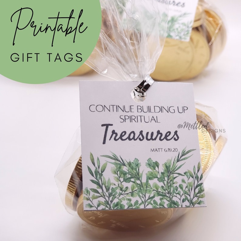 May include: Printable gift tag with a white background and green foliage design. The tag says "Continue building up spiritual treasures" with the scripture reference "Matt 6:19,20" and the social media handle "@mettleddesigns".