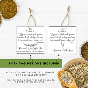 May include: Two white square tags with twine, featuring text and floral designs. One tag reads "Homemade Citrus Herb Salt" with ingredients listed. The other says "Seasoned With Love." Both tags include a Bible verse.