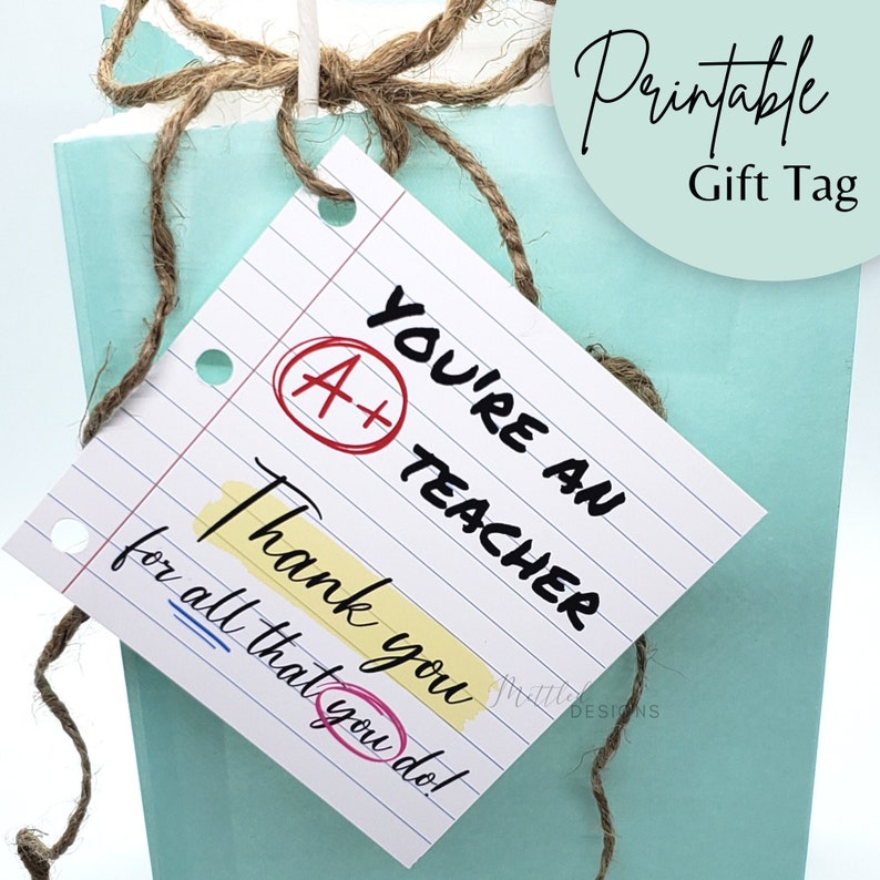 May include: A printable gift tag with a blue and white background. The tag has a handwritten message that says "You're an A+ Teacher Thank you for all that you do!"