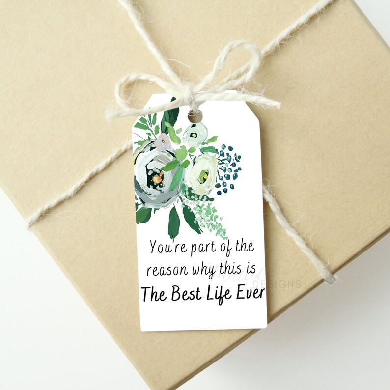 May include: White gift tag with a floral design in shades of green, white, and blue. The tag has the text "You're part of the reason why this is The Best Life Ever."