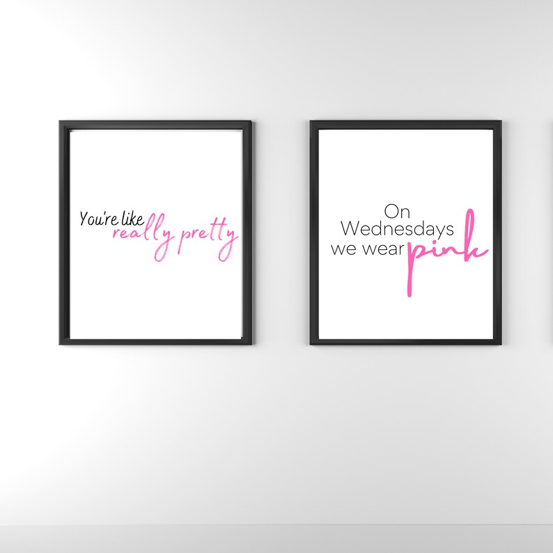 May include: Two framed prints with black frames and white backgrounds. The left print has the text "You're like really pretty" in pink cursive. The right print has the text "On Wednesdays we wear pink" in black with "pink" in pink cursive.