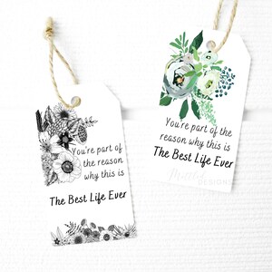 May include: Two white gift tags with black and white floral designs and the text "You're part of the reason why this is The Best Life Ever".