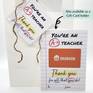 May include: A white card with a red circle and the text "You're an A+ Teacher" and a yellow rectangle with the text "Thank you for all that you do!"  The card has a space to write "to:" and "from:" at the bottom. A red and orange gift card for Grubhub is attached to the card.
