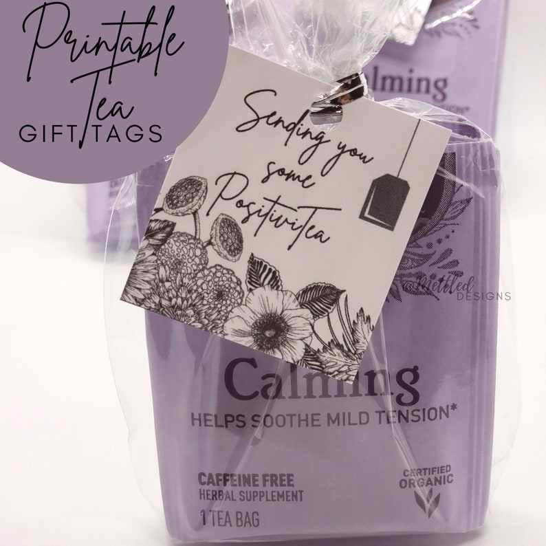 May include: A lavender tea bag gift set with a tag that reads "Sending you some PositiviTea." The tag features floral illustrations and a tea bag graphic. The tea box is labeled "Calming" and "Caffeine Free Herbal Supplement."