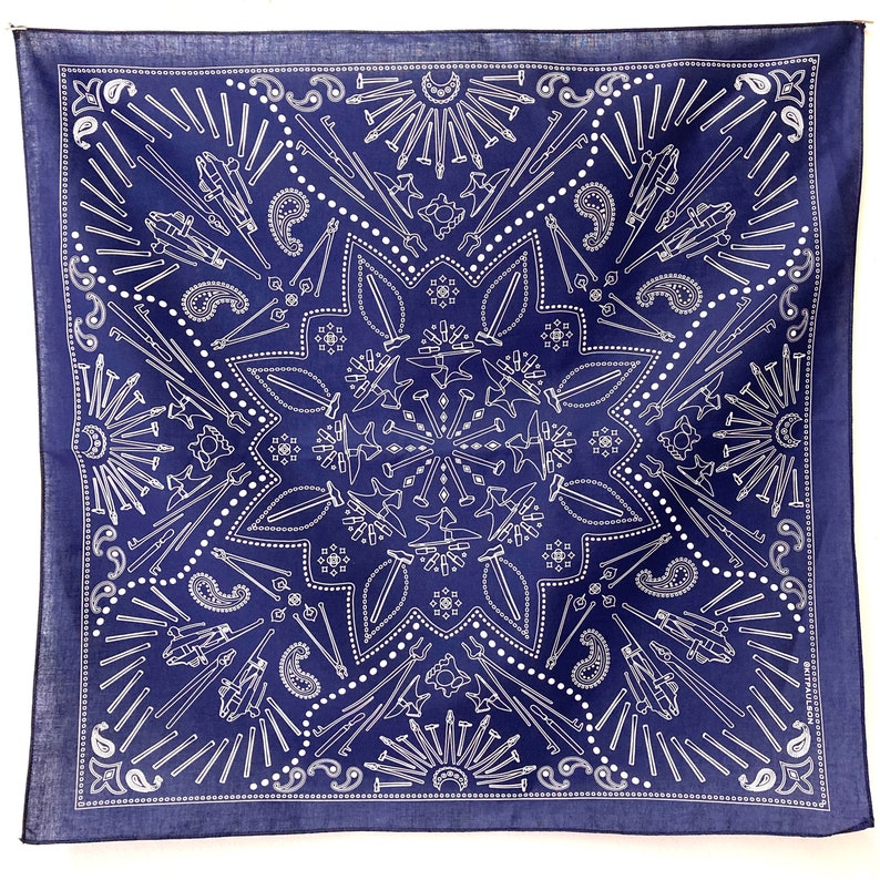 Puede incluir: Un pa&ntilde;uelo azul con un dise&ntilde;o blanco de varias herramientas y un patr&oacute;n paisley. Las herramientas incluyen martillos, yunques y clavos.